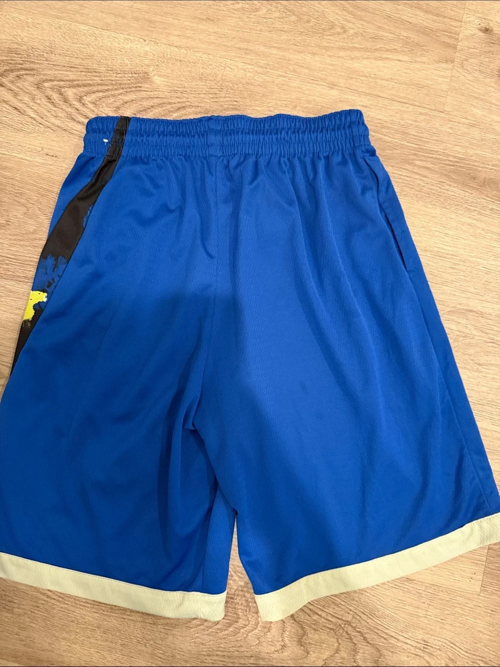 Nike Blue Athletic Shorts with Black Swoosh and Yellow Accent